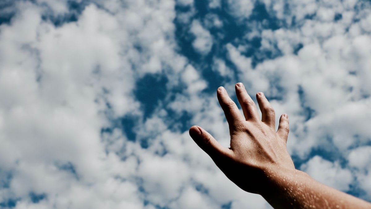 Sky with a persons hand reaching out